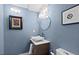 Chic powder room with a unique marble sink and stylish lighting fixtures showcases modern elegance at 9505 Poundstone Pl, Greenwood Village, CO 80111