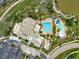 Aerial view of the community center including a pool with a waterslide and ample parking at 16256 Ute Peak Way, Broomfield, CO 80023