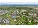 Aerial view showcasing a community center with pools, lakes, parks, and mountain views at 16256 Ute Peak Way, Broomfield, CO 80023