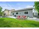 Charming backyard with a stone fire pit, manicured lawn, and a cozy patio for outdoor gatherings at 16256 Ute Peak Way, Broomfield, CO 80023