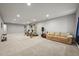 Large finished basement with carpeted floor, home gym, neutral walls, recessed lighting and cozy seating area at 16256 Ute Peak Way, Broomfield, CO 80023