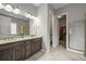 Double sink bathroom with modern fixtures and a view into the spacious walk-in closet at 16256 Ute Peak Way, Broomfield, CO 80023
