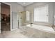 Luxurious bathroom features a glass-enclosed shower, soaking tub, and elegant tile work at 16256 Ute Peak Way, Broomfield, CO 80023