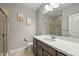 Bathroom featuring a modern vanity with a white countertop, dark wood cabinets and shower with glass door at 16256 Ute Peak Way, Broomfield, CO 80023