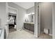Bathroom with double vanity, and a view of the bedroom and separate water closet at 16256 Ute Peak Way, Broomfield, CO 80023