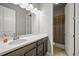 Bathroom featuring a modern vanity with a white countertop, dark wood cabinets and shower with curtain at 16256 Ute Peak Way, Broomfield, CO 80023