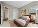 Bedroom with natural light, neutral walls, wood accents, closet, and calming artwork, creating a comfortable retreat at 16256 Ute Peak Way, Broomfield, CO 80023