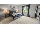 Bright bedroom featuring a cozy bed, stylish nightstands, and sheer dark curtains at 16256 Ute Peak Way, Broomfield, CO 80023