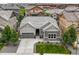 Charming single-Gathering home features neutral toned exterior, landscaped yard, and a convenient two-car attached garage at 16256 Ute Peak Way, Broomfield, CO 80023