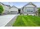 A well-manicured lawn enhances this beautiful home, complete with a two-car attached garage and welcoming front entrance at 16256 Ute Peak Way, Broomfield, CO 80023