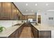 Gourmet kitchen features a gas cooktop, a large center island, stainless steel appliances, and ample cabinet space at 16256 Ute Peak Way, Broomfield, CO 80023