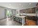 Beautiful kitchen features granite countertops, stainless steel appliances, a center island with seating, and wood floors at 16256 Ute Peak Way, Broomfield, CO 80023