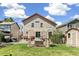 Well-maintained backyard with outdoor seating area, pergola, and a lush green lawn at 4150 S Rome St, Aurora, CO 80018