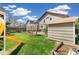 Gathering-friendly backyard with play structure, lush lawn, a storage shed, and mature landscaping at 4150 S Rome St, Aurora, CO 80018