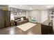 Finished basement with dark wood floors, a leather sofa, and ample storage at 4150 S Rome St, Aurora, CO 80018