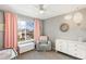 Cozy bedroom with a ceiling fan, decorative mirror, and ample sunlight at 4150 S Rome St, Aurora, CO 80018