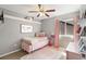 Bright bedroom featuring pink accents, plush rug, and ample natural light at 4150 S Rome St, Aurora, CO 80018