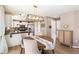 Cozy dining room with hardwood floors, modern lighting, and seamless flow into the kitchen at 4150 S Rome St, Aurora, CO 80018
