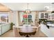 Elegant dining area with hardwood floors, a round table, and natural light at 4150 S Rome St, Aurora, CO 80018