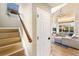 Inviting entryway with hardwood stairs and view of the living room with vaulted ceilings at 4150 S Rome St, Aurora, CO 80018