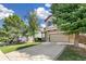 Charming two-story home with a two-car garage and a well-maintained lawn at 4150 S Rome St, Aurora, CO 80018