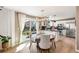 Bright kitchen with a breakfast nook, black backsplash, stainless steel appliances, and hardwood floors at 4150 S Rome St, Aurora, CO 80018
