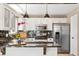 Kitchen with granite counters, stainless appliances, black tile backsplash, and wood floors at 4150 S Rome St, Aurora, CO 80018