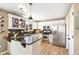 Bright kitchen featuring granite counters, stainless appliances, and black tile backsplash at 4150 S Rome St, Aurora, CO 80018