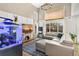 Bright living room featuring hardwood floors, a fireplace, and a decorative fish tank at 4150 S Rome St, Aurora, CO 80018