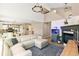 Open-concept living area with fireplace, and hardwood floors leading to the kitchen and dining area at 4150 S Rome St, Aurora, CO 80018