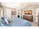Bright main bedroom features modern lighting, vaulted ceilings, and en suite bathroom access at 4150 S Rome St, Aurora, CO 80018
