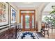 Elegant foyer featuring a decorative front door, wooden accents and stylish decor at 2069 Garrison St, Lakewood, CO 80215