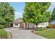 Inviting home with a well-manicured lawn, mature trees, and an attached three-car garage at 2069 Garrison St, Lakewood, CO 80215