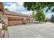 Attached three-car garage with ample driveway space, providing convenience and extra parking at 2069 Garrison St, Lakewood, CO 80215