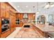Gourmet kitchen featuring a large island, granite countertops, and modern appliances at 2069 Garrison St, Lakewood, CO 80215