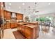 Gourmet kitchen featuring a large island, stone countertops, and modern appliances at 2069 Garrison St, Lakewood, CO 80215
