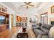 Open-concept living room featuring hardwood floors, custom ceiling and fireplace at 2069 Garrison St, Lakewood, CO 80215