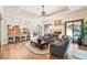 Spacious living room featuring hardwood floors, a fireplace, and an open layout to the kitchen at 2069 Garrison St, Lakewood, CO 80215