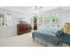 Large main bedroom with a dresser, a ceiling fan, a bed and a window with white shutters at 2069 Garrison St, Lakewood, CO 80215
