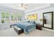 Comfortable main bedroom with large windows, a ceiling fan and a bed with blue covers at 2069 Garrison St, Lakewood, CO 80215