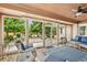 Bright sunroom with large windows offers views of the landscaped backyard at 2069 Garrison St, Lakewood, CO 80215