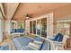 Relaxing sunroom with wicker furniture, a ceiling fan, and sliding glass doors at 2069 Garrison St, Lakewood, CO 80215