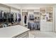 Neatly organized walk-in closet with shelving, drawers, hanging and ample storage space at 2069 Garrison St, Lakewood, CO 80215