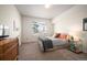 Sunlit bedroom showcasing a queen-size bed, modern furnishings, and a cozy ambiance at 111 S Monroe St # B104, Denver, CO 80209