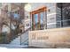 Inviting condo entrance with stone facade, copper awning, and clear signage at 111 S Monroe St # B104, Denver, CO 80209