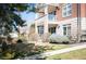 Charming home exterior with manicured lawn, complemented by a balcony and well-maintained landscaping at 111 S Monroe St # B104, Denver, CO 80209