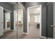 Hallway leading to the bedroom with mirror and white trim doors at 111 S Monroe St # B104, Denver, CO 80209