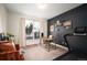 Bright home office with dark accent wall, modern desk setup, and sliding door access at 111 S Monroe St # B104, Denver, CO 80209
