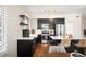 Modern kitchen with stainless steel appliances, quartz countertops, and dark cabinets at 111 S Monroe St # B104, Denver, CO 80209