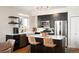 Stylish kitchen featuring black cabinets, stainless steel appliances, and a center island with seating at 111 S Monroe St # B104, Denver, CO 80209